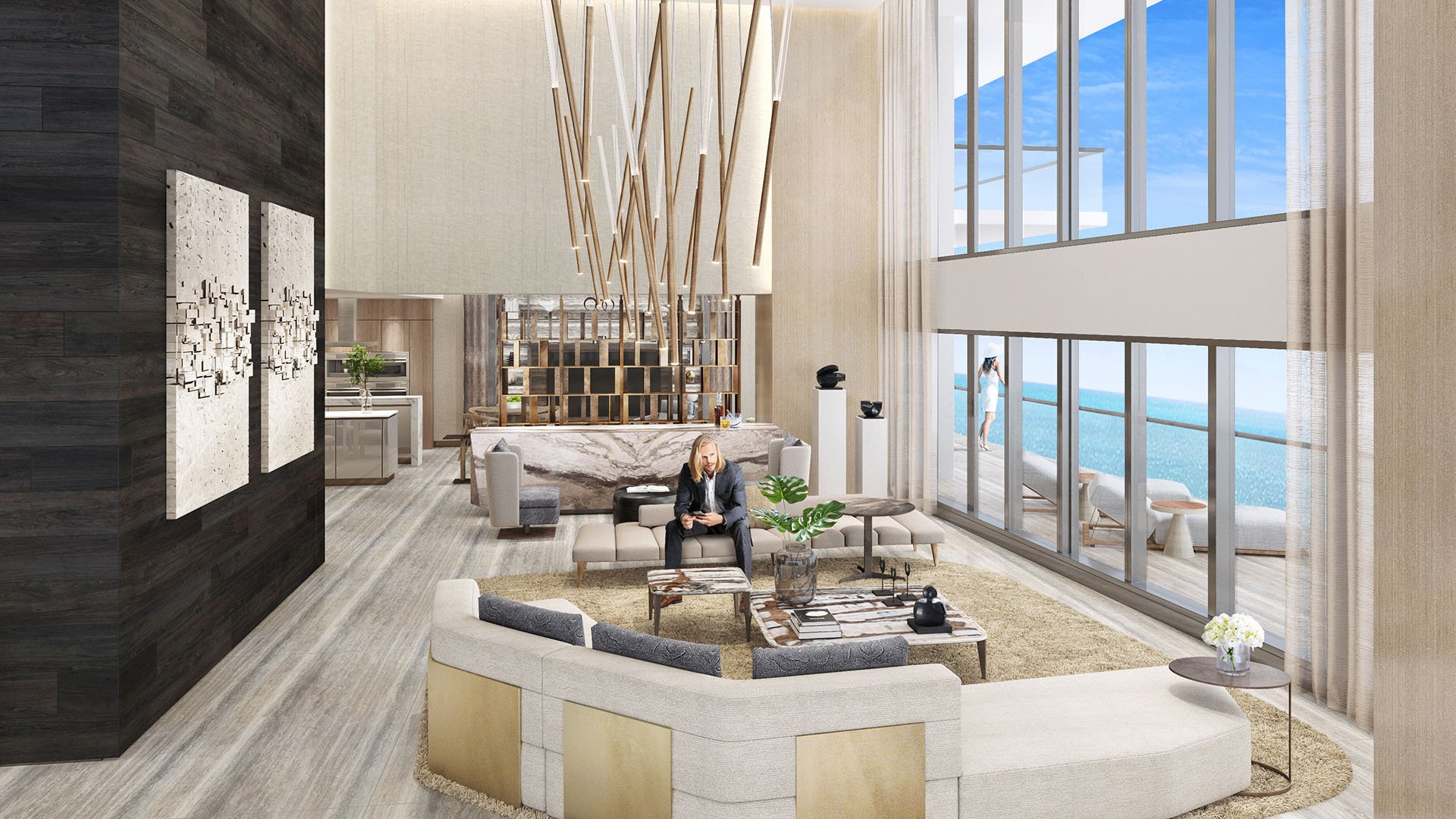 Turnberry Ocean Club in Sunny Isles Beach luxury and ultra luxury condos showcase a double-height great room with a dramatic wall of glass and oceanfront seating areas.