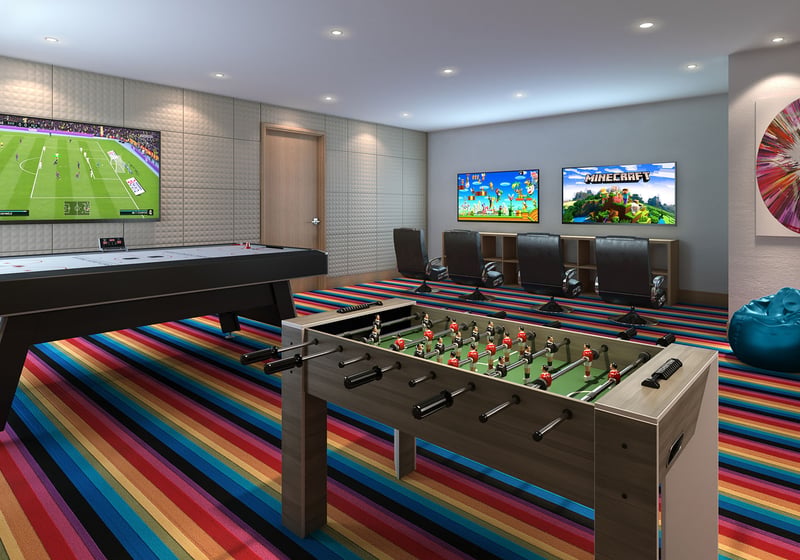 Turnberry Ocean Club in Sunny Isles Beach luxury and ultra luxury condos showcase a gaming room with foosball, air hockey, striped carpet, and wall-mounted screens.