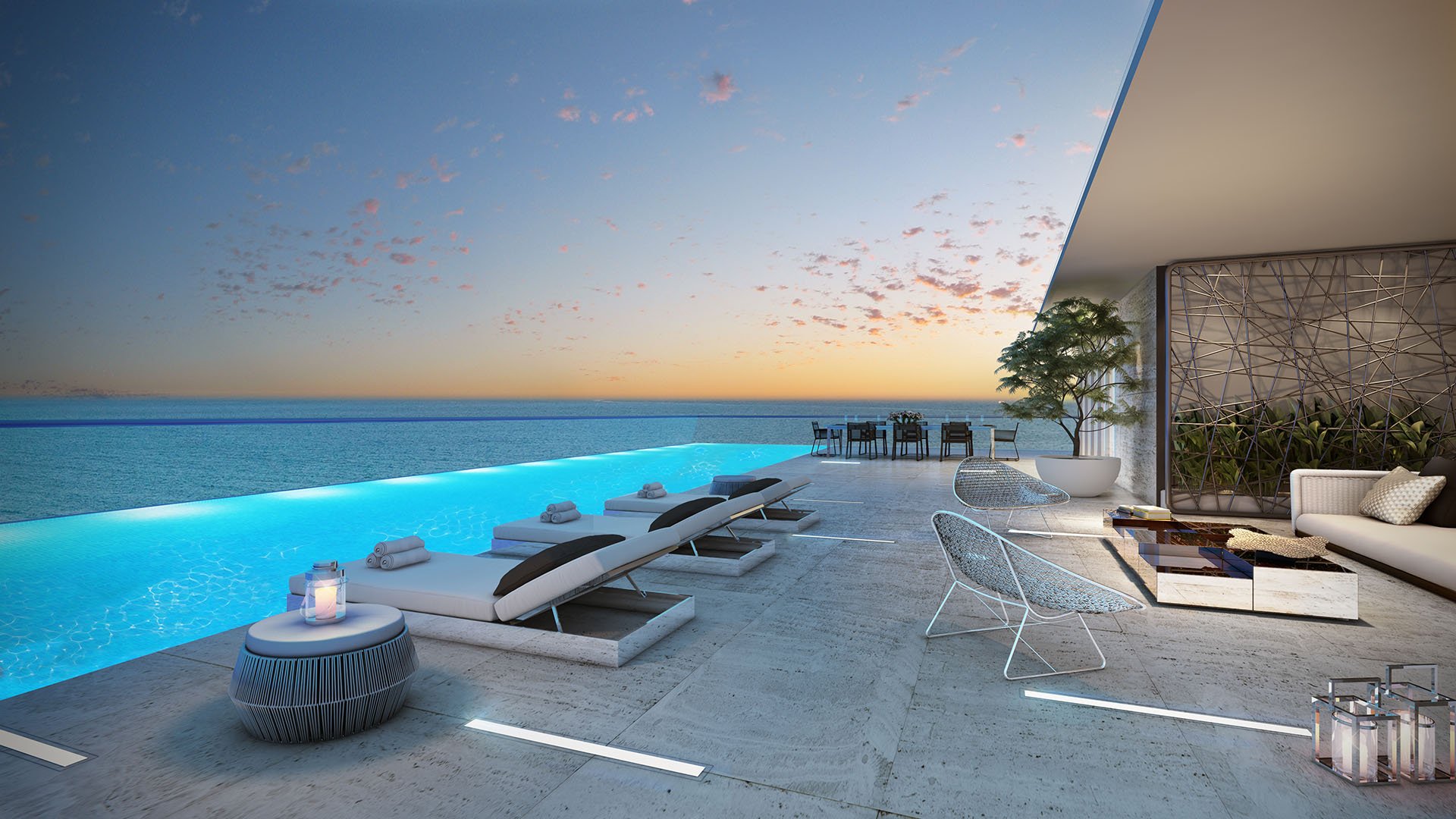Turnberry Ocean Club in Sunny Isles Beach luxury and ultra luxury condos showcase an infinity-edge terrace pool with submerged loungers and uninterrupted ocean views.