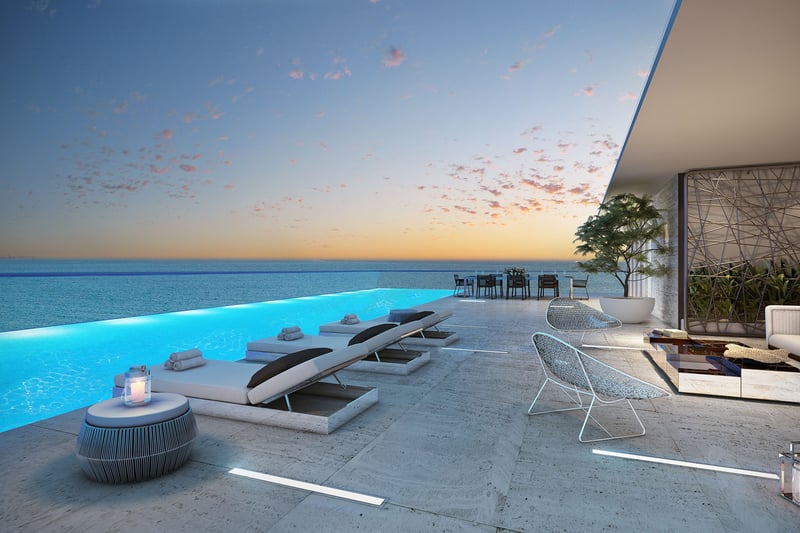 Turnberry Ocean Club in Sunny Isles Beach luxury and ultra luxury condos showcase an infinity-edge terrace pool with submerged loungers and uninterrupted ocean views.