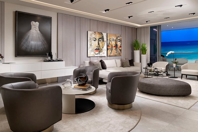 Turnberry Ocean Club in Sunny Isles Beach luxury and ultra luxury condos showcase a twilight living room with ocean views, lounge seating, and a curated gallery wall.