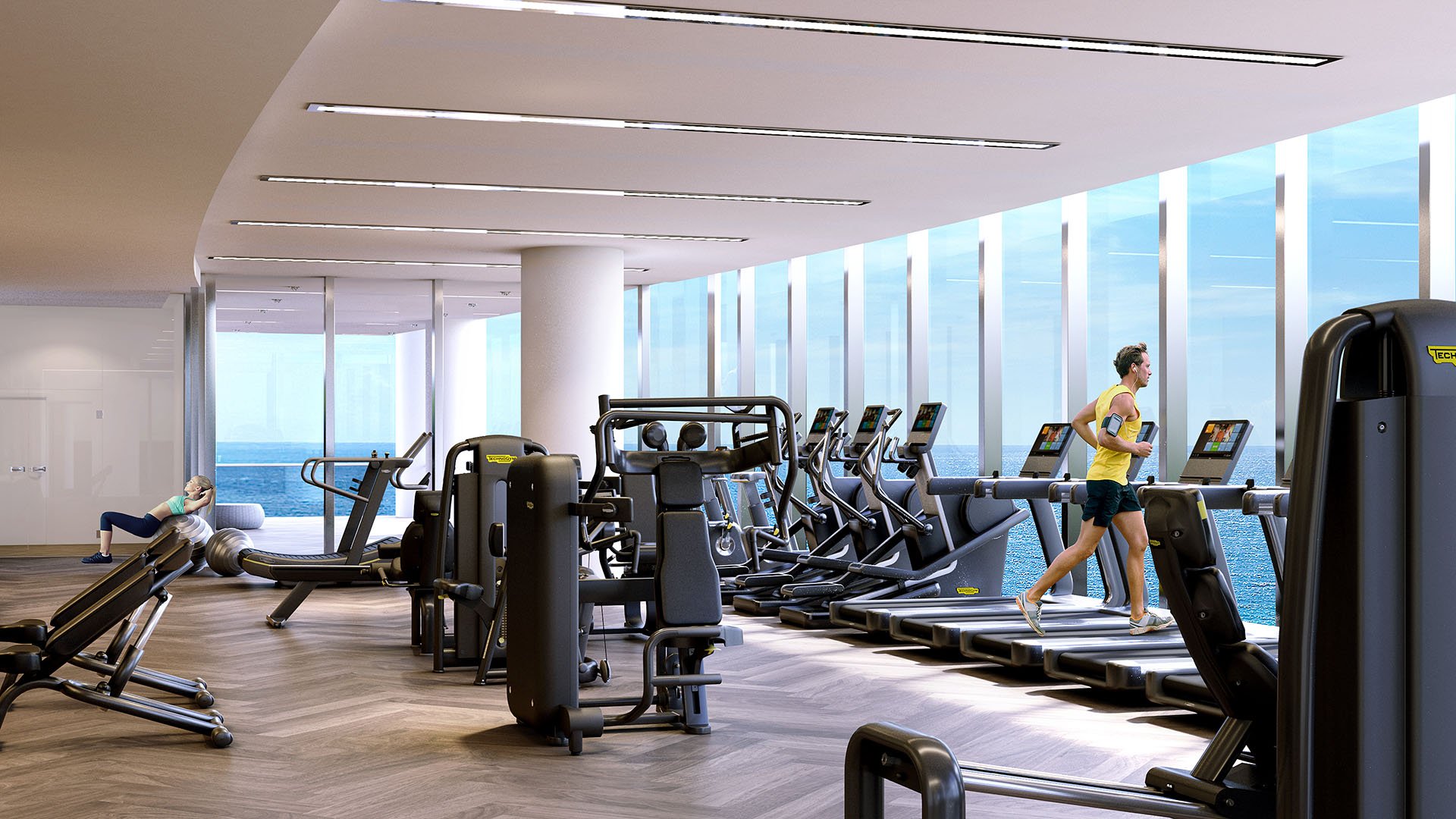 Turnberry Ocean Club in Sunny Isles Beach luxury and ultra luxury condos showcase an oceanfront fitness center with cardio equipment, strength machines, and floor-to-ceiling glass.