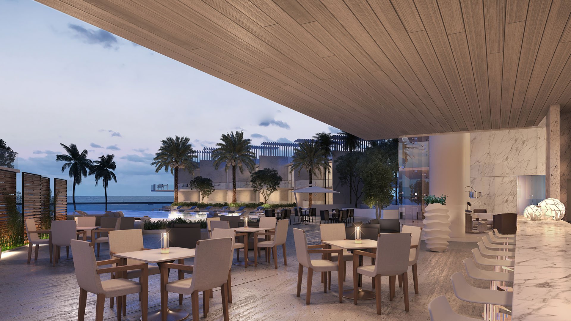 Turnberry Ocean Club in Sunny Isles Beach luxury and ultra luxury condos showcase an outdoor pool bar terrace at dusk with dining tables, lounge chairs, and waterfront ambience.