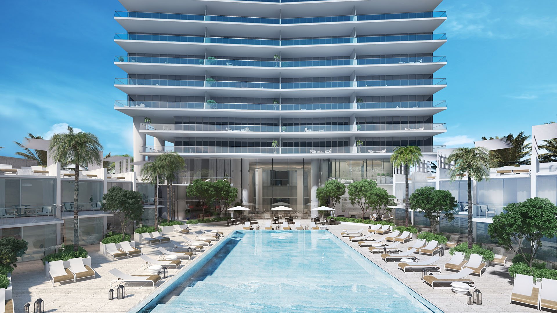 Turnberry Ocean Club in Sunny Isles Beach luxury and ultra luxury condos showcase a beachfront perspective of the pool deck and cabanas framed by the tower facade.