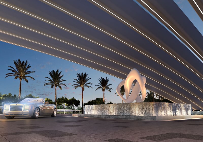 Turnberry Ocean Club in Sunny Isles Beach luxury and ultra luxury condos showcase a porte cochere with sweeping canopy lines, sculpture fountain, palms, and a luxury arrival drive.