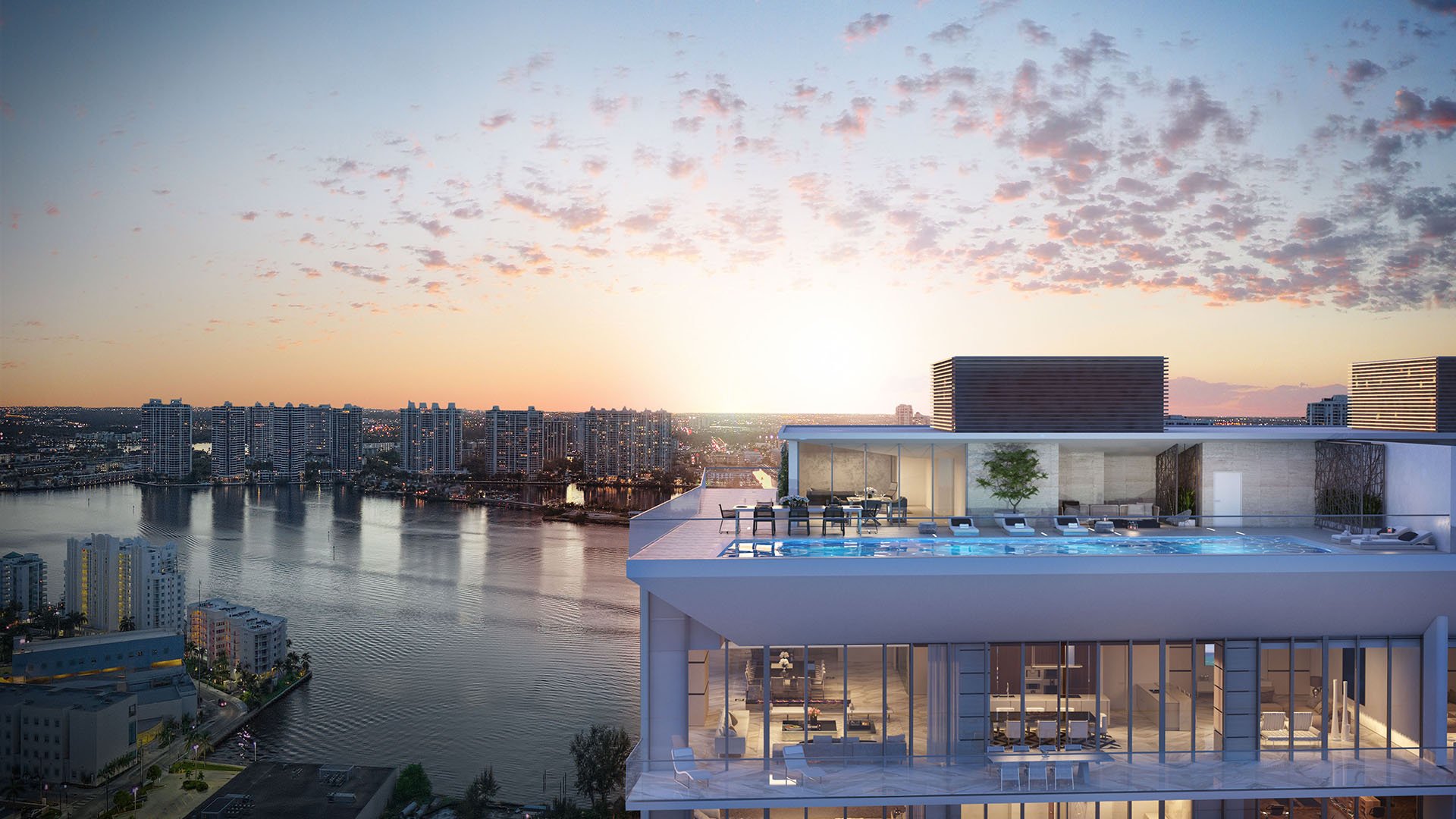 Turnberry Ocean Club in Sunny Isles Beach luxury and ultra luxury condos showcase a rooftop residence aerial with bay water, glowing interiors, and a sunset sky.