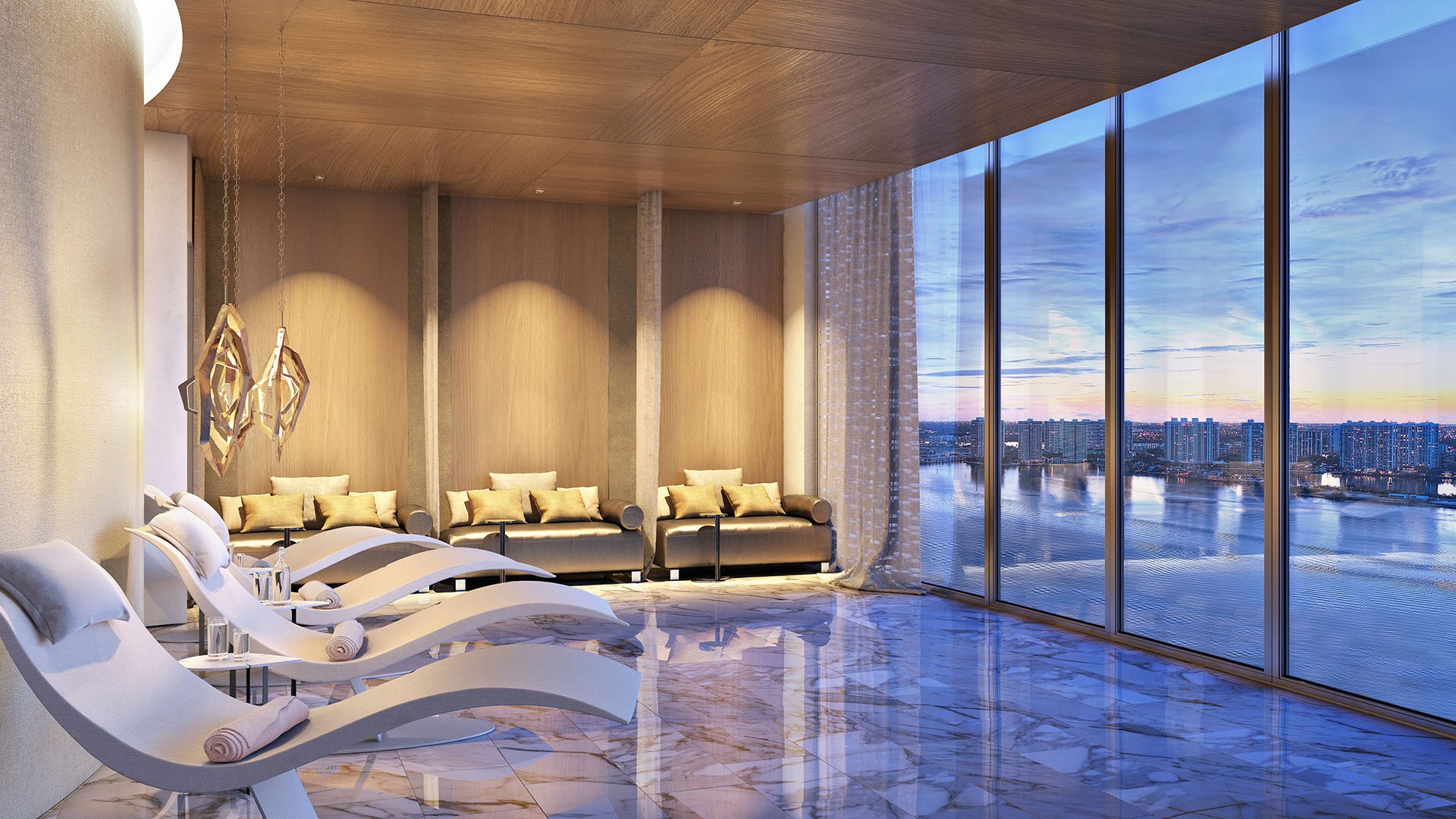 Turnberry Ocean Club in Sunny Isles Beach luxury and ultra luxury condos showcase a spa relaxation room with sculptural loungers, marble floors, and waterfront views.