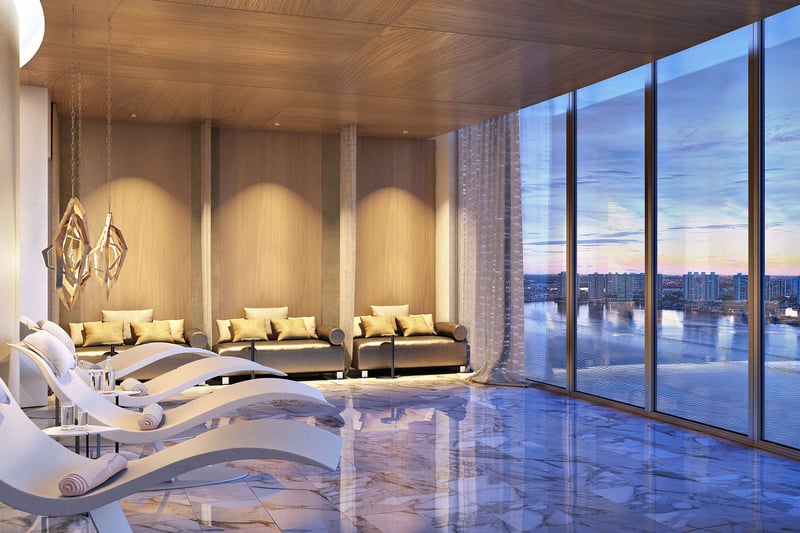 Turnberry Ocean Club in Sunny Isles Beach luxury and ultra luxury condos showcase a spa relaxation room with sculptural loungers, marble floors, and waterfront views.