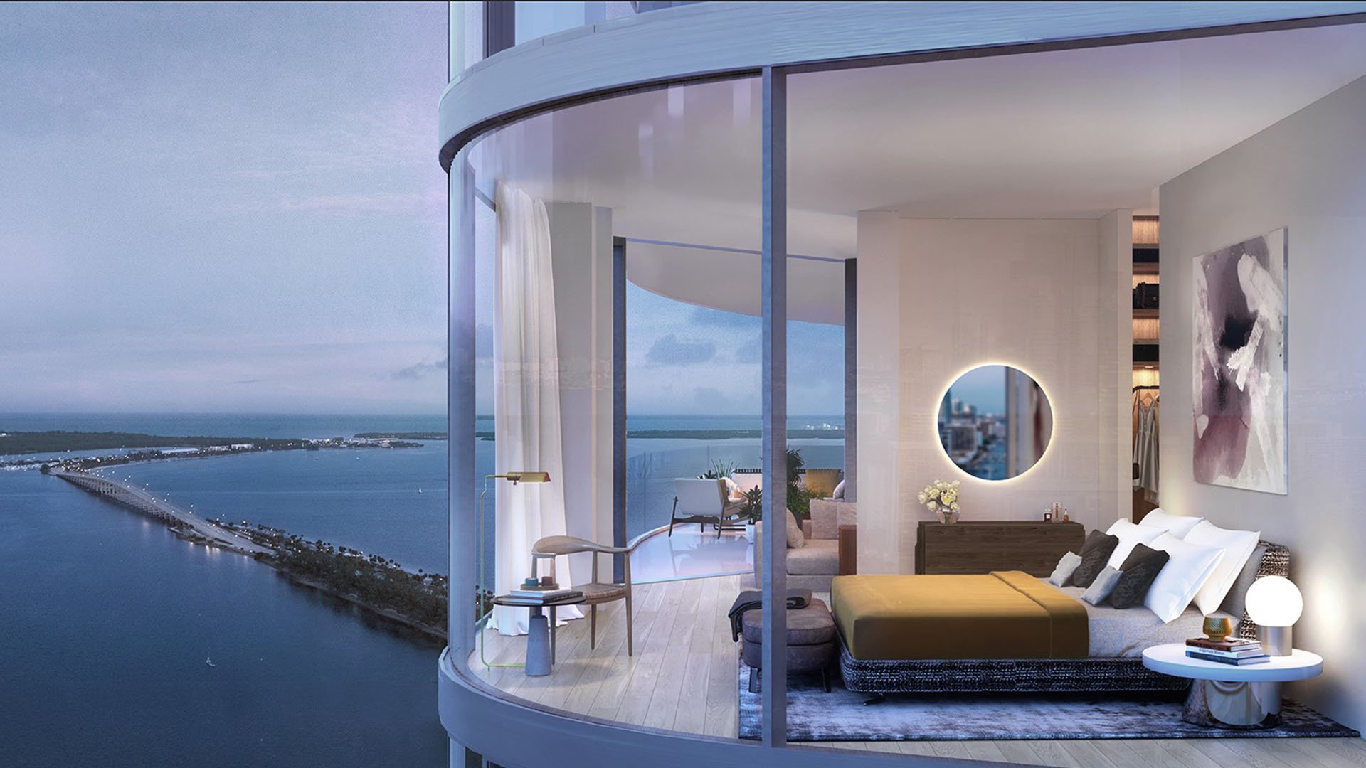 Una Residences Brickell, Miami corner bedroom suite with curved glass wall, king bed and Biscayne Bay bridge dusk view, showcasing luxury and ultra luxury preconstruction condos with waterfront skyline vistas.