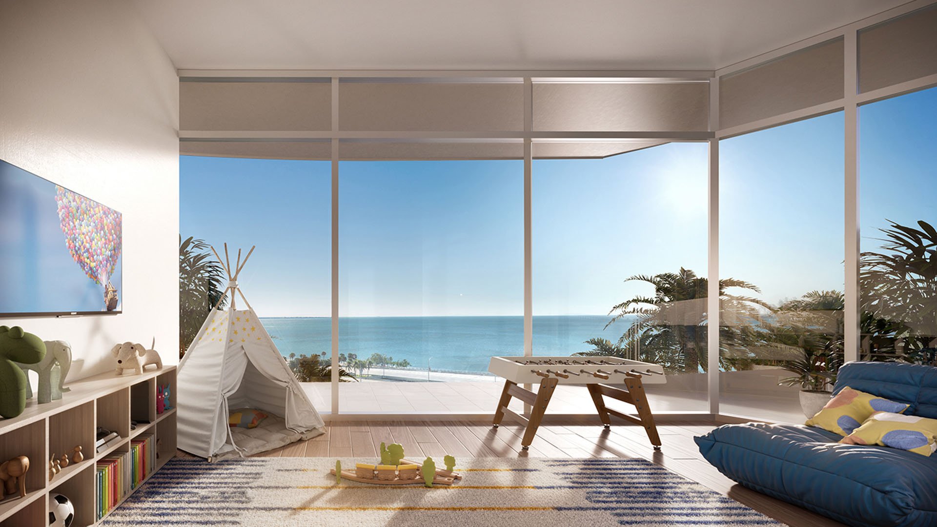 Una Residences Brickell, Miami kids playroom and family game lounge with teepee, foosball table and floor-to-ceiling windows with water views, highlighting luxury and ultra luxury preconstruction condos with family-friendly amenities.