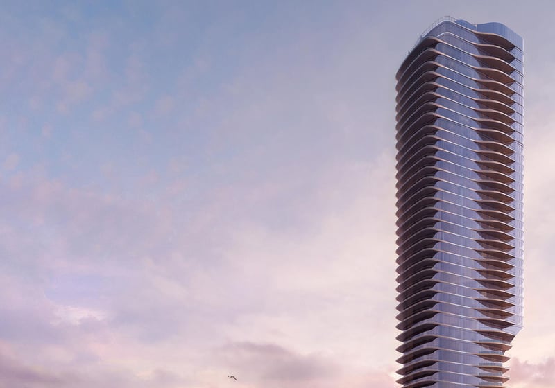 Una Residences Brickell, Miami residential tower exterior at dusk, curved glass balconies rising above the skyline, showcasing luxury and ultra luxury preconstruction condos and signature architecture on Biscayne Bay.