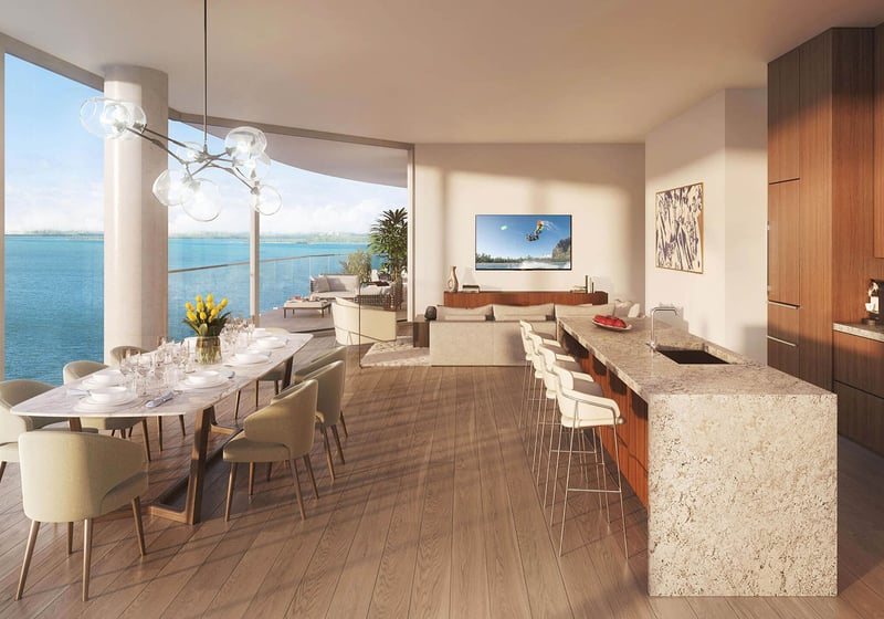Una Residences Brickell, Miami open-concept great room with dining table, gourmet kitchen island and bay-view terrace, featuring luxury and ultra luxury preconstruction condos with expansive floor plans and waterfront vistas.