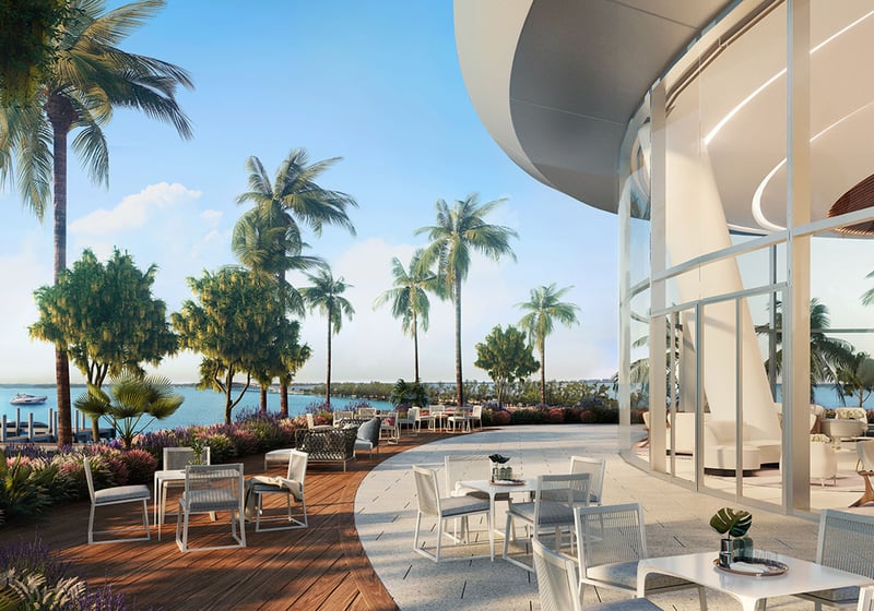 Una Residences Brickell, Miami residents lounge terrace with outdoor dining, palm-lined patio and waterfront views near the marina, showcasing luxury and ultra luxury preconstruction condos lifestyle in Brickell.
