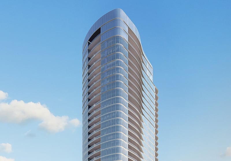 Una Residences Brickell, Miami waterfront condominium tower exterior in daylight with rounded glass balconies and sleek facade, representing luxury and ultra luxury preconstruction condos on the Biscayne Bay shoreline.