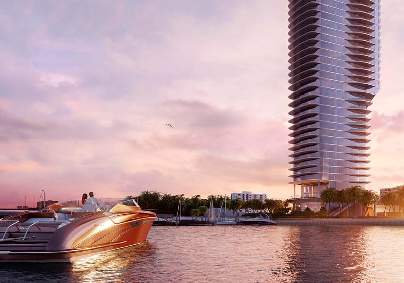 Una Residences Brickell, Miami waterfront tower and speedboat on Biscayne Bay at sunset, capturing the luxury and ultra luxury preconstruction condos lifestyle with marina access and iconic coastal skyline views.