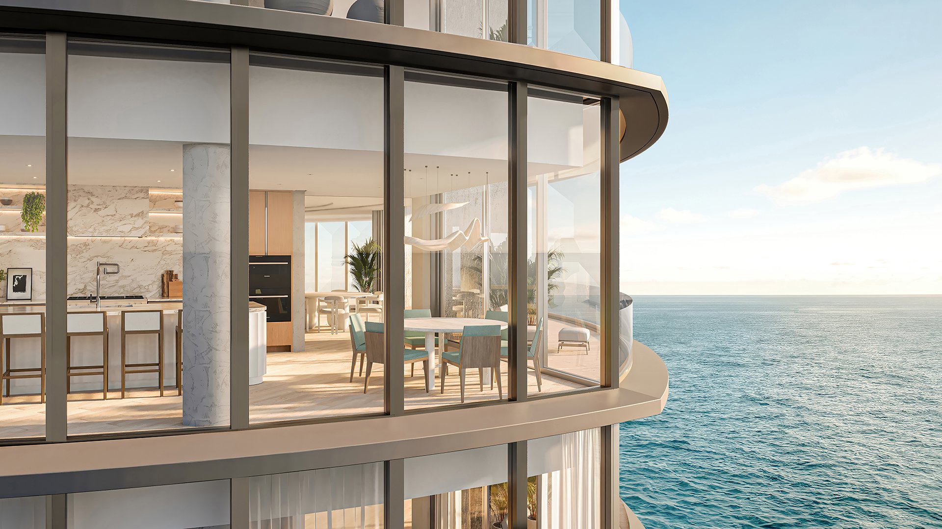 Upper Penthouse Rivage in Bal Harbour luxury and ultra luxury condos curved glass exterior showing a chef kitchen and dining area beside wraparound ocean views.