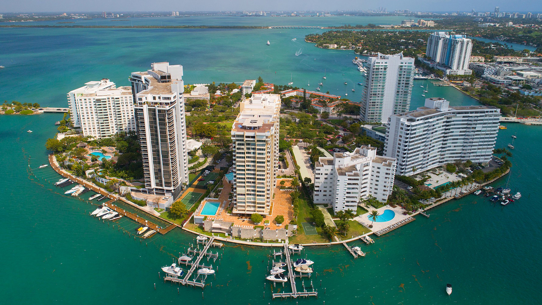 Venetian Islands, Miami coastal high‑rise and marina aerial, bayfront zone linking to luxury and ultra luxury condos. Featuring island view.