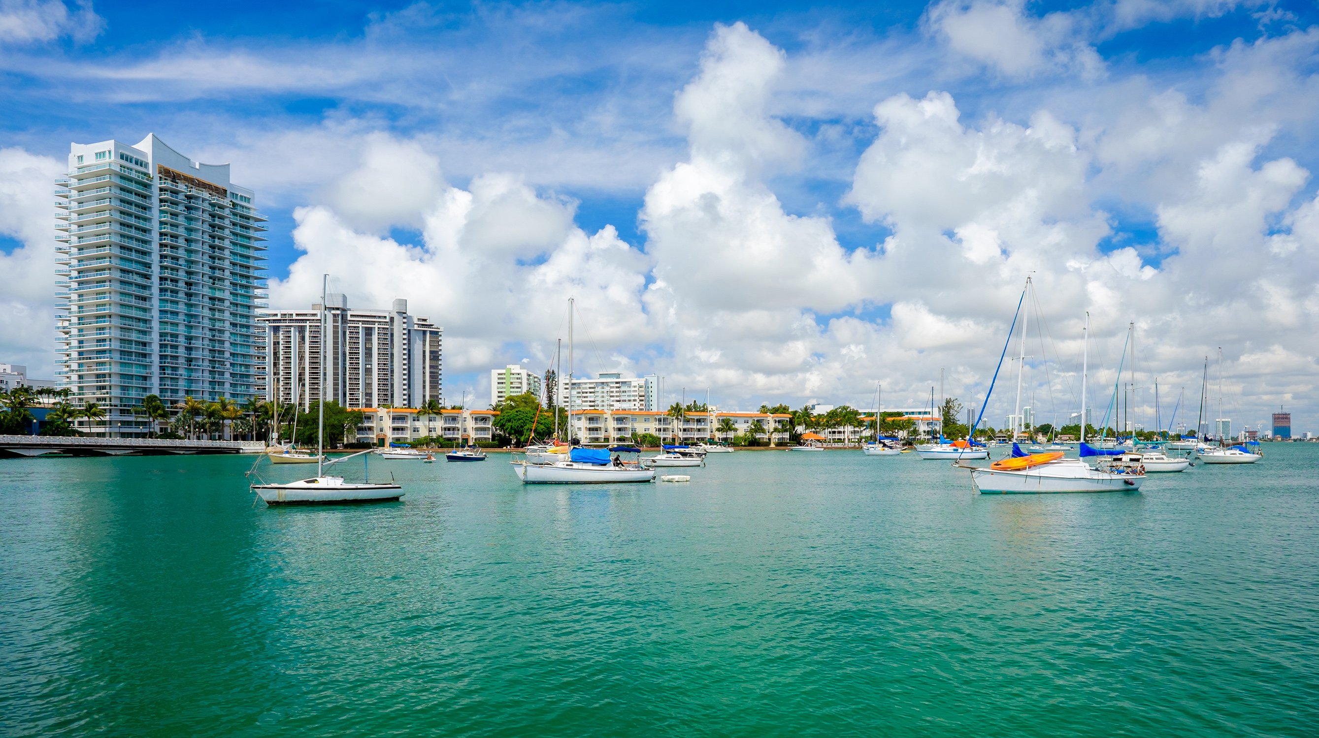 Venetian Islands marina with sailing boats and Miami skyline, bay lifestyle near luxury and ultra luxury condos. Featuring island.