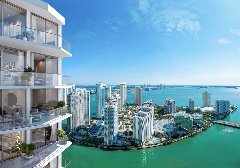 Viceroy Brickell The Residences in Brickell, Miami, luxury and ultra luxury preconstruction condos with corner balconies overlooking turquoise bayfront water, nearby towers, and a sweeping aerial skyline view.