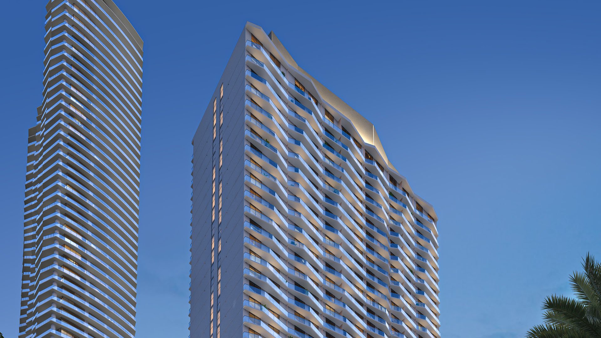 Viceroy Brickell The Residences in Brickell, Miami, luxury and ultra luxury preconstruction condos with a street-level exterior view highlighting the curved tower facade and illuminated balconies against the evening sky.