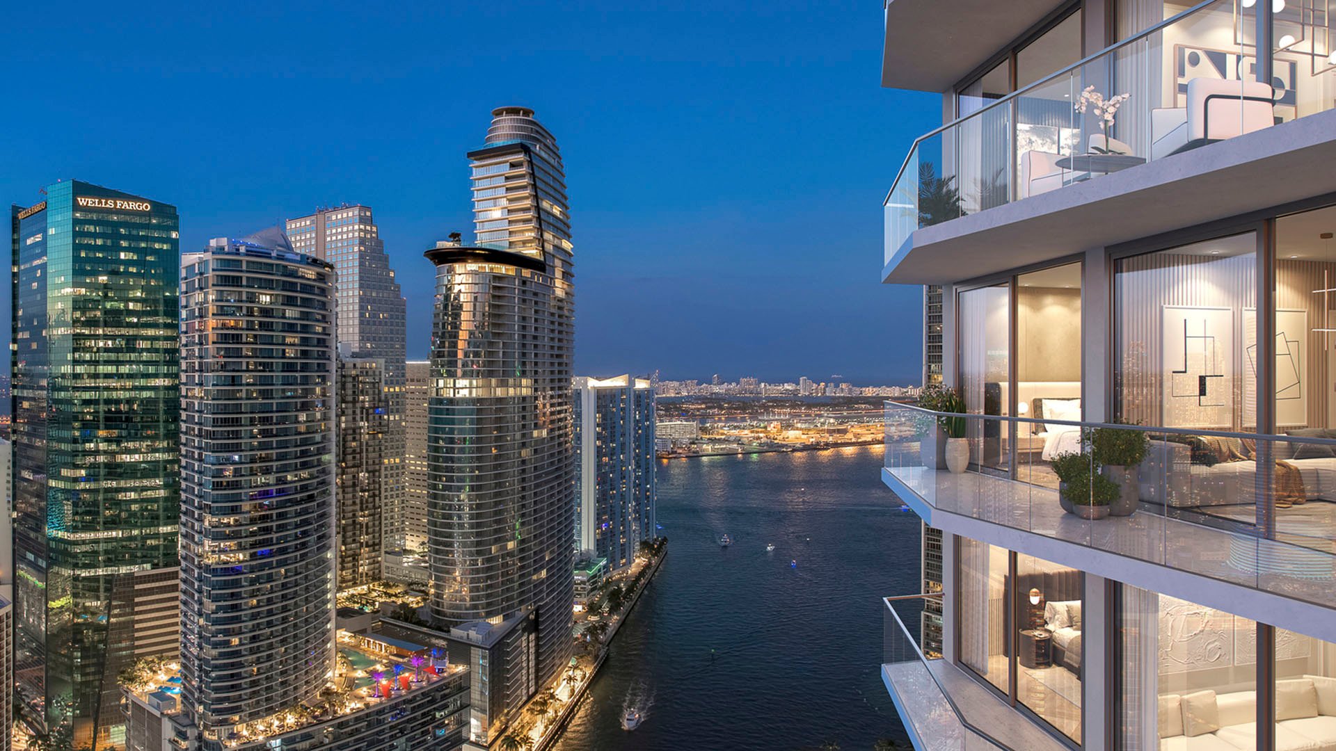 Viceroy Brickell The Residences in Brickell, Miami, luxury and ultra luxury preconstruction condos with a dusk balcony view over a waterfront channel, illuminated towers, and the downtown skyline.