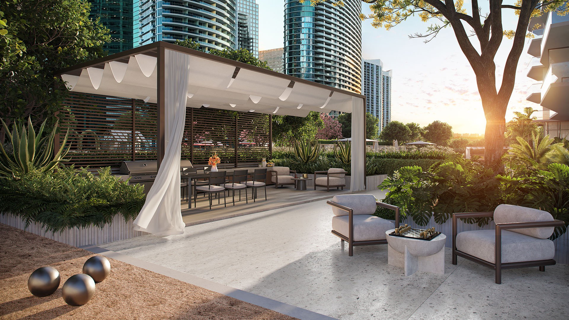 Viceroy Brickell The Residences in Brickell, Miami, luxury and ultra luxury preconstruction condos with a pergola lounge, summer kitchen, outdoor dining table, seating area, and a bocce court at sunset.
