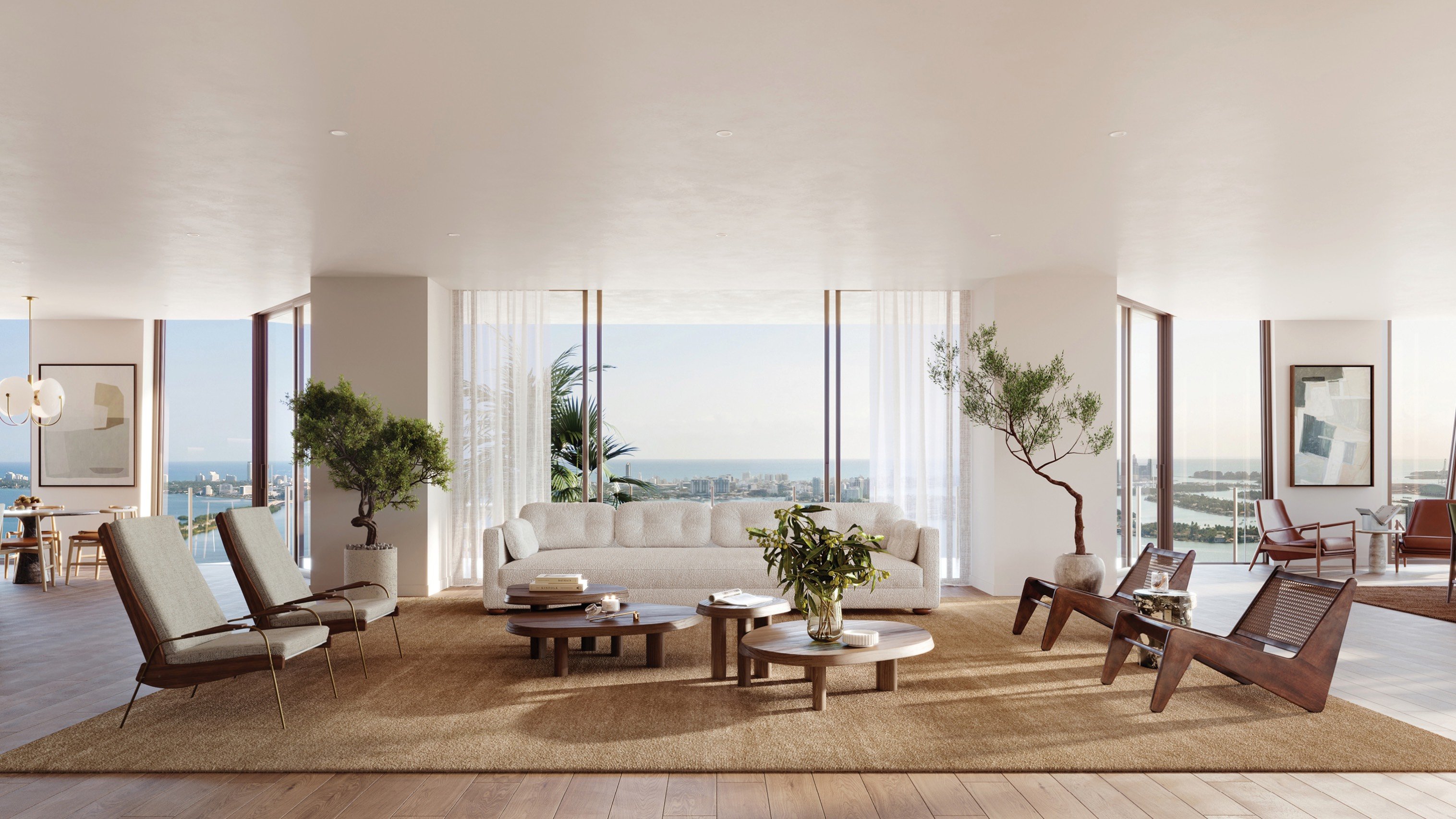 Villa Miami, Edgewater living room framing an ocean view through floor‑to‑ceiling glass; luxury and ultra luxury condos on Biscayne Bay, Miami, preconstruction.