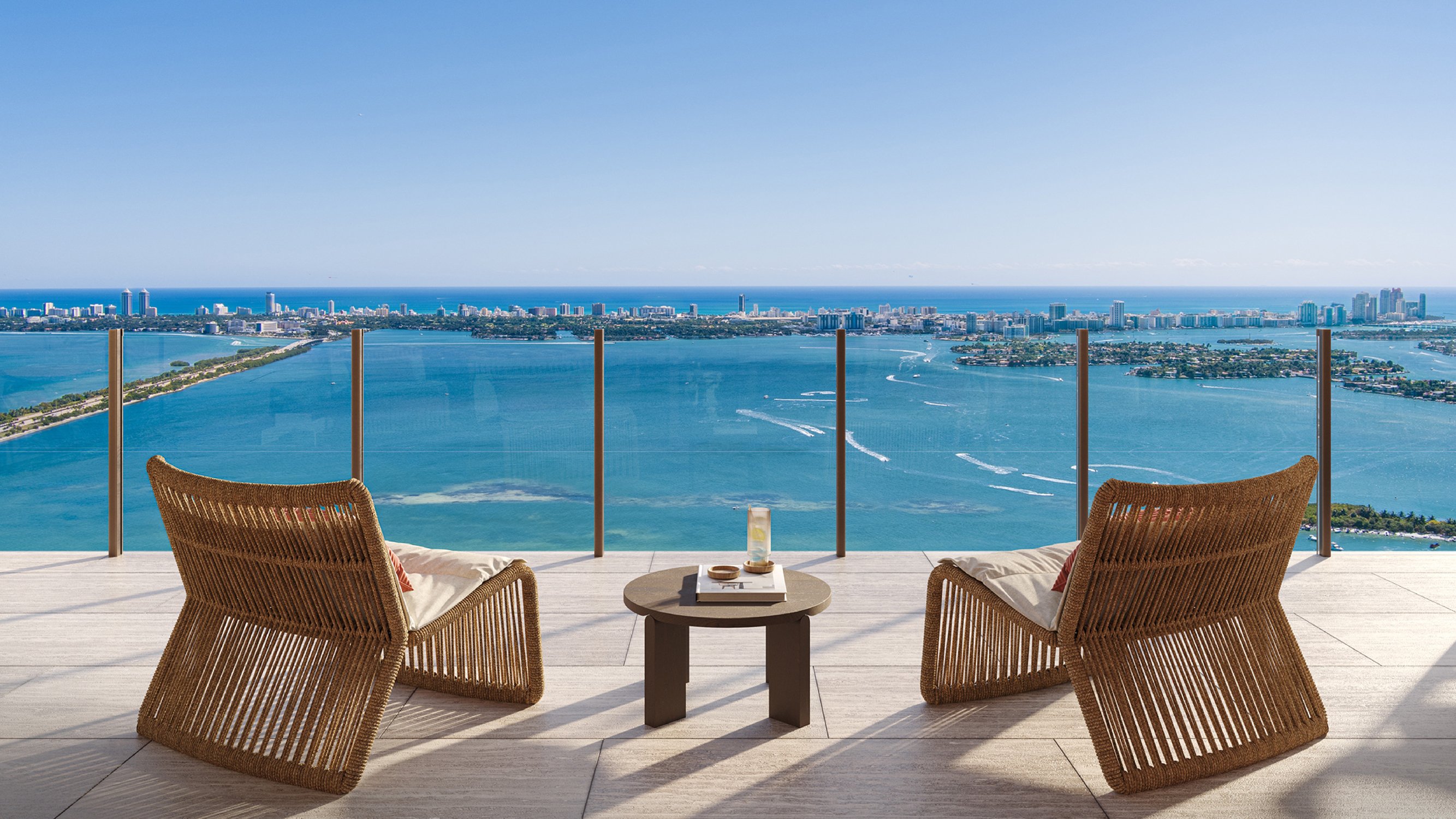 Villa Miami, Edgewater ocean‑view balcony with lounge chairs and glass rail, indoor‑outdoor living for luxury and ultra luxury condos; preconstruction.