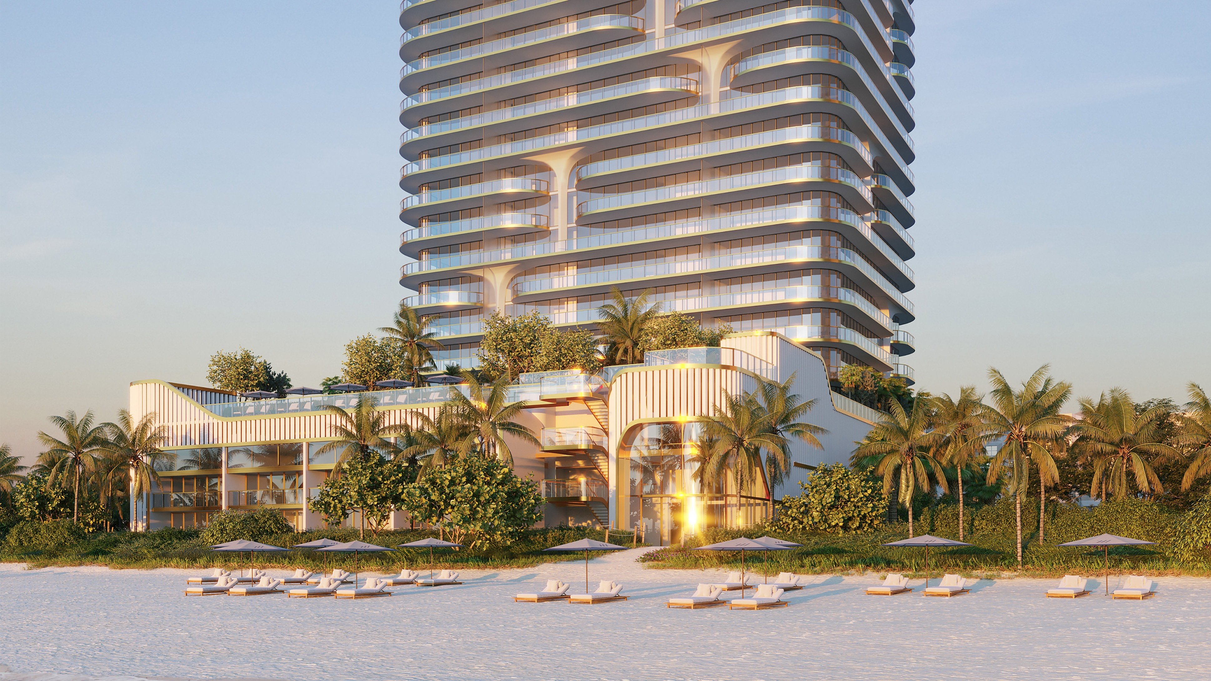 Waldorf Astoria Residences Pompano Beach oceanfront condo at sunset with glowing glass, ultra luxury and luxury condos; preconstruction. Featuring beachfront and modern.