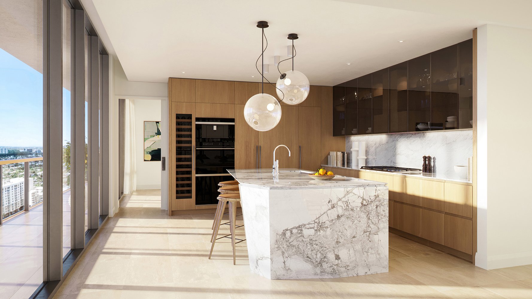 Waldorf Astoria Residences Pompano Beach chef’s kitchen with slab island and integrated appliances, entertainer’s layout in luxury and ultra luxury condos; preconstruction. Featuring modern interior design.
