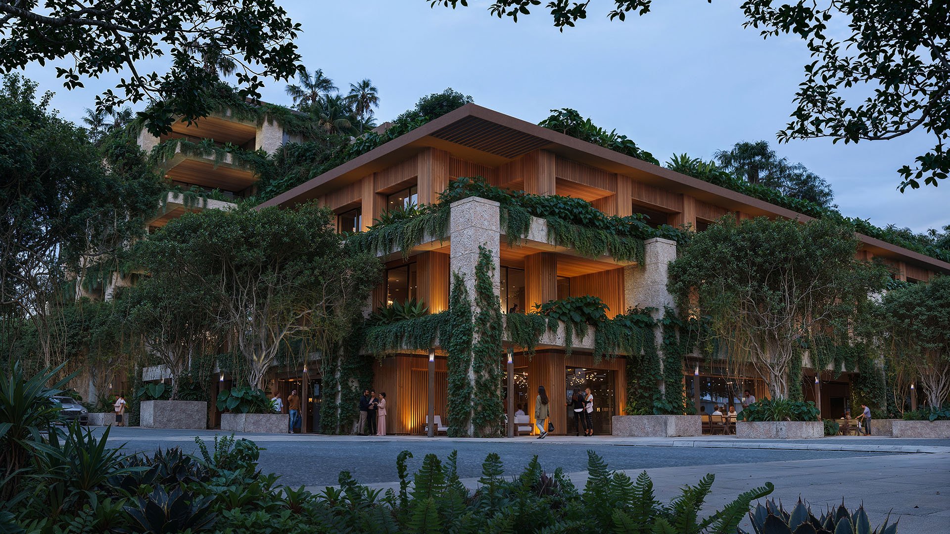 Vine-covered corner exterior at Ziggurat on Florida Ave and Matilda Street, Coconut Grove, Miami, Florida, at dusk, showcasing luxury street retail and ultra luxury preconstruction condos with warm architectural lighting.