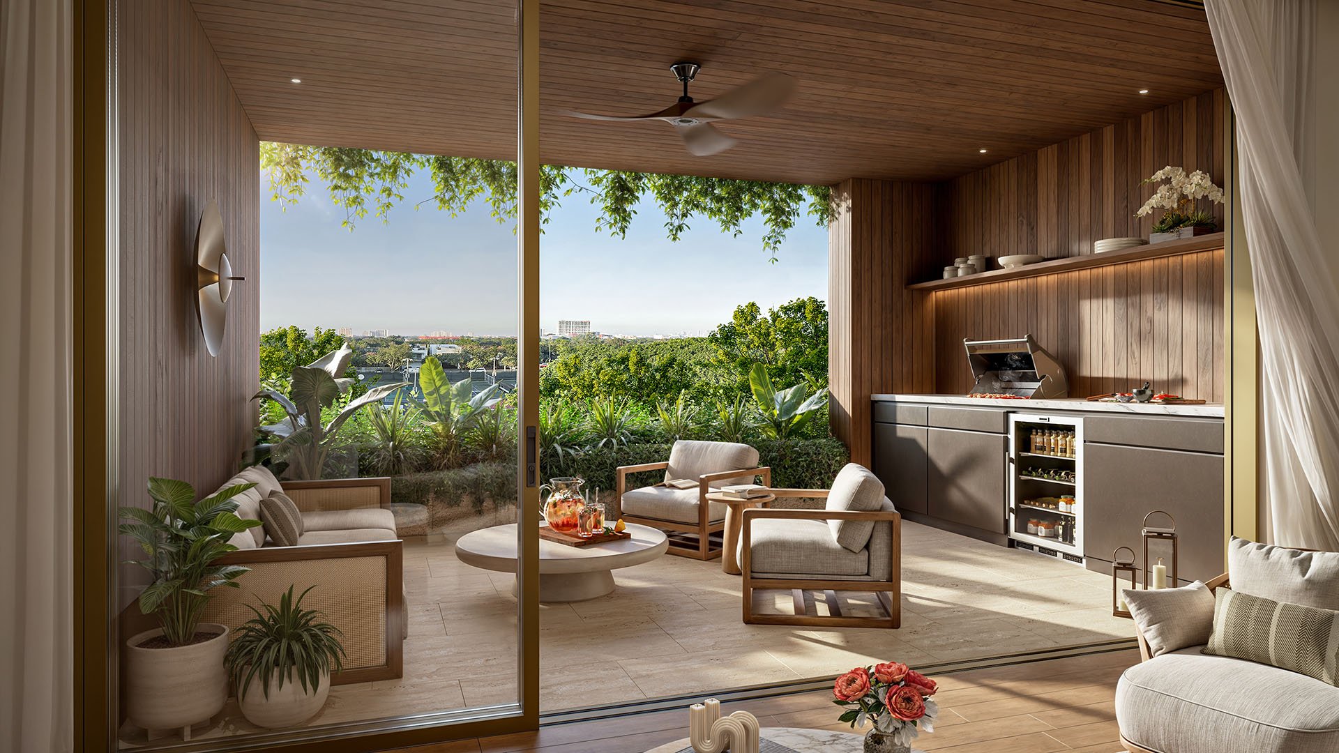 Private terrace with outdoor kitchen and lounge seating at Ziggurat Coconut Grove, Miami, Florida, overlooking treetops, showcasing luxury indoor-outdoor living and ultra luxury preconstruction condos with a custom grill station.