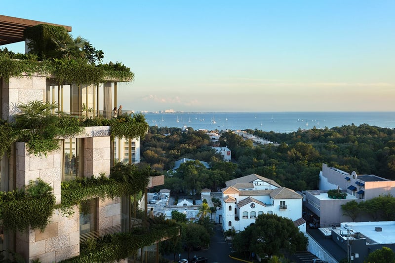 Green-terrace facade of Ziggurat Coconut Grove, Miami, Florida, overlooking Biscayne Bay and sailboats, highlighting luxury outdoor living and ultra luxury preconstruction condos with panoramic water views.