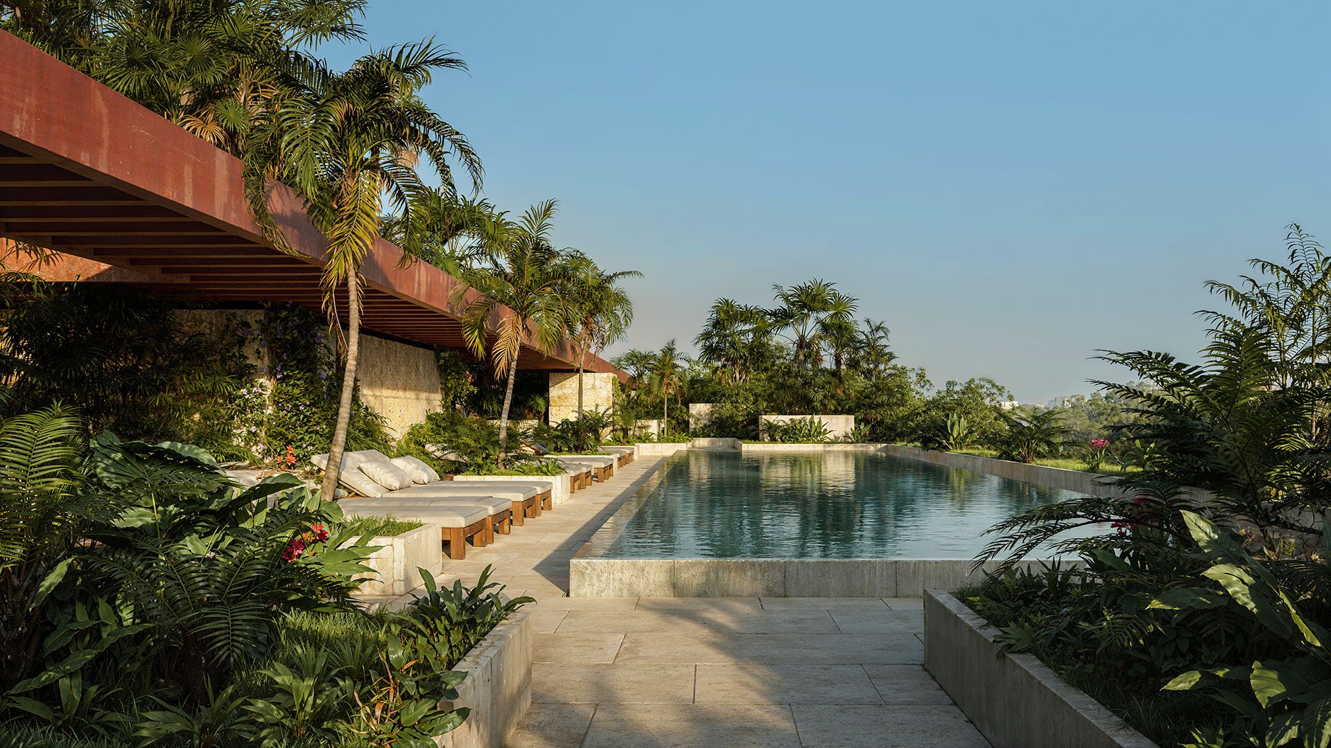 Rooftop infinity pool and sun deck at Ziggurat Coconut Grove, Miami, Florida, with loungers, palms and tropical landscaping, showcasing luxury resort amenities and ultra luxury preconstruction condos.