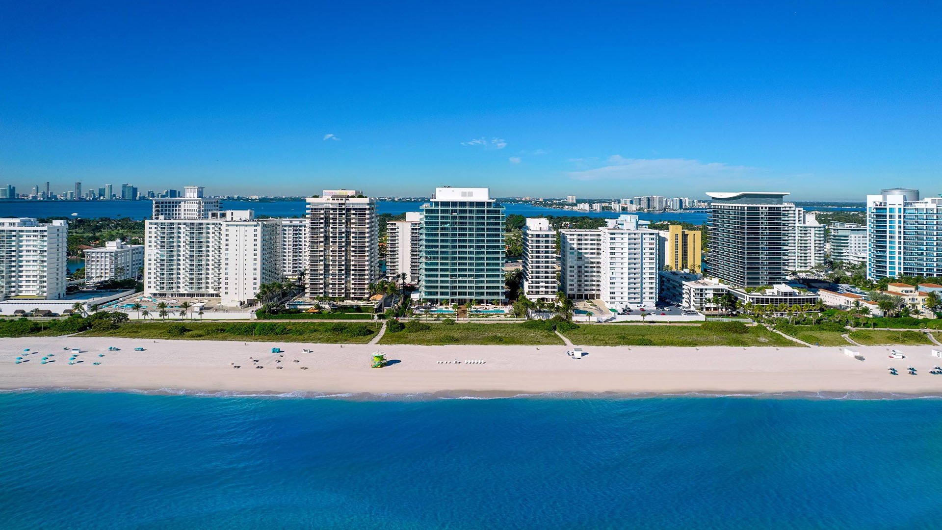 57 Ocean Miami Beach modern balcony with city skyline at sunset, showcasing luxury and ultra luxury preconstruction condos on Millionaire's Row, Mid-Beach, Miami Beach, Florida.