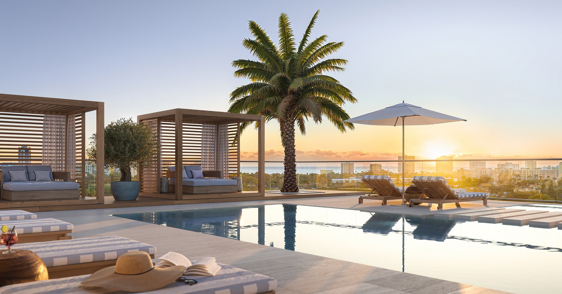 The Rooftop Pool at Glass House boasts a lushly landscaped roof deck, accentuated by magnificent water and golf course views that create a serene ambiance for relaxation and leisure activities.