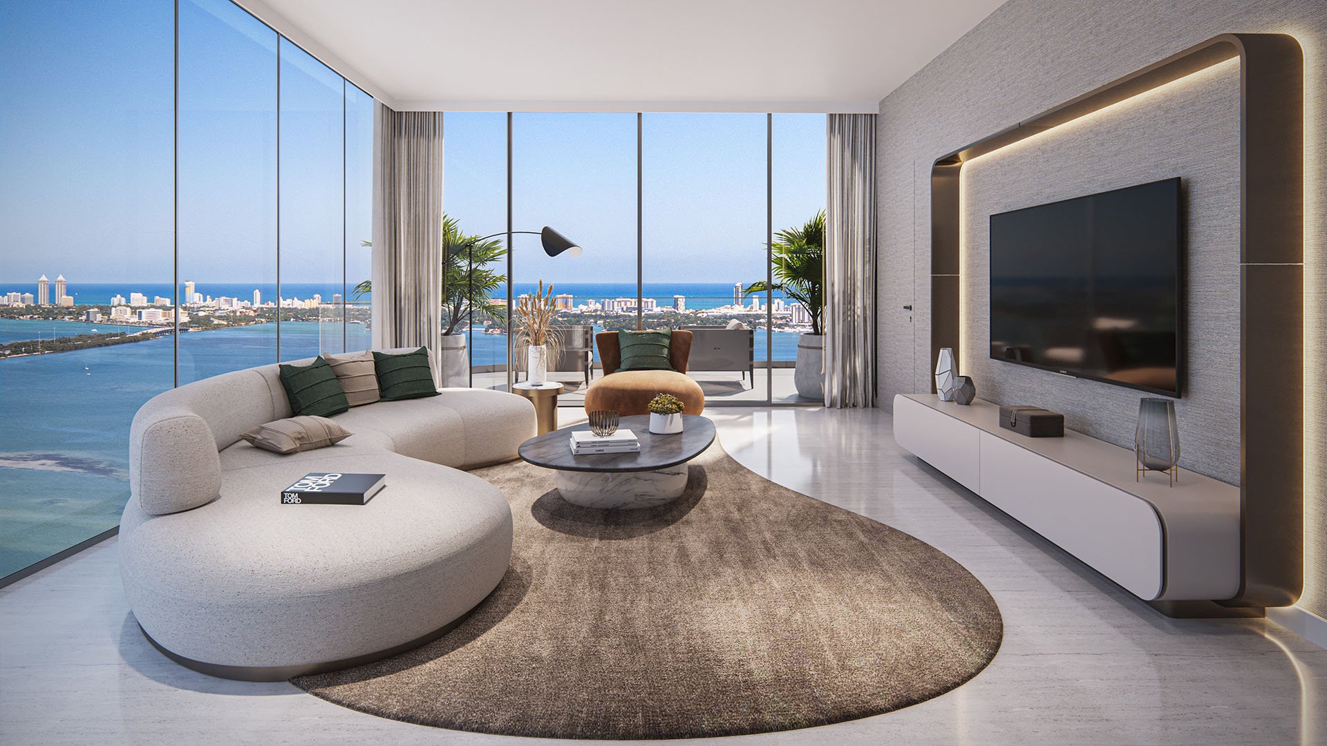 Aria Reserve Edgewater Miami living room with curved sofa, media wall and panoramic Biscayne Bay to Miami Beach views, highlighting luxury and ultra luxury preconstruction condos with expansive balconies.