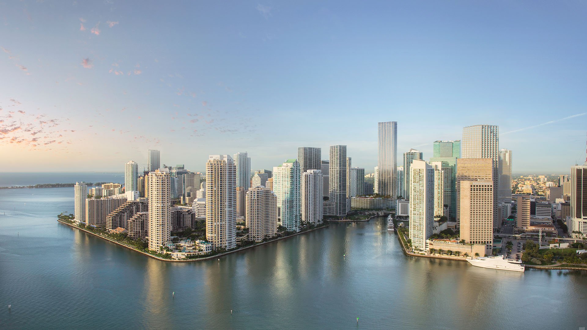 Baccarat Residences in Brickell, Miami, luxury and ultra luxury condos featuring a daylight aerial of the waterfront skyline, calm bay water, and high-rise towers.