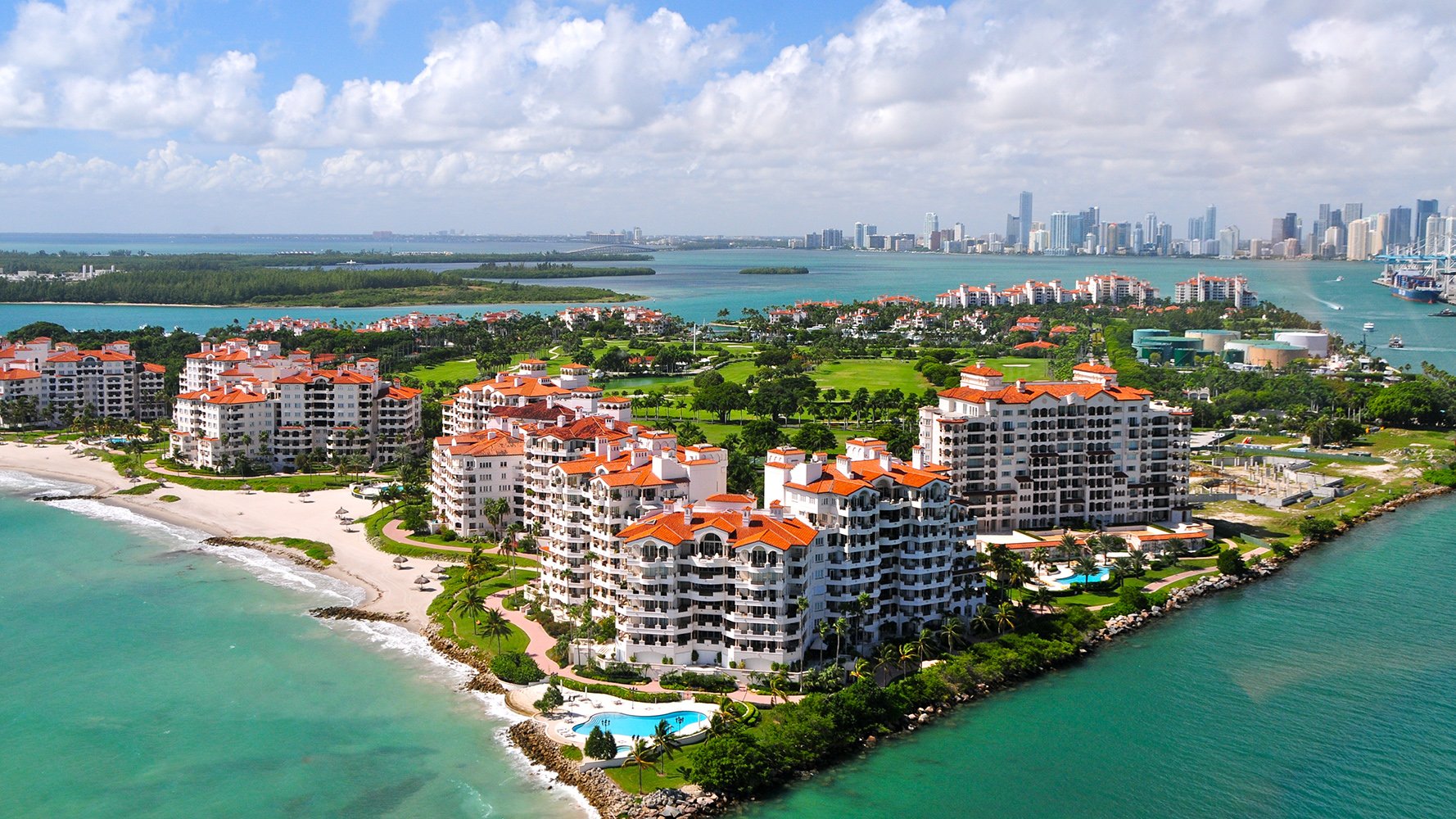 Fisher Island luxury oceanfront condos near Miami Beach with private beaches and panoramic skyline views.