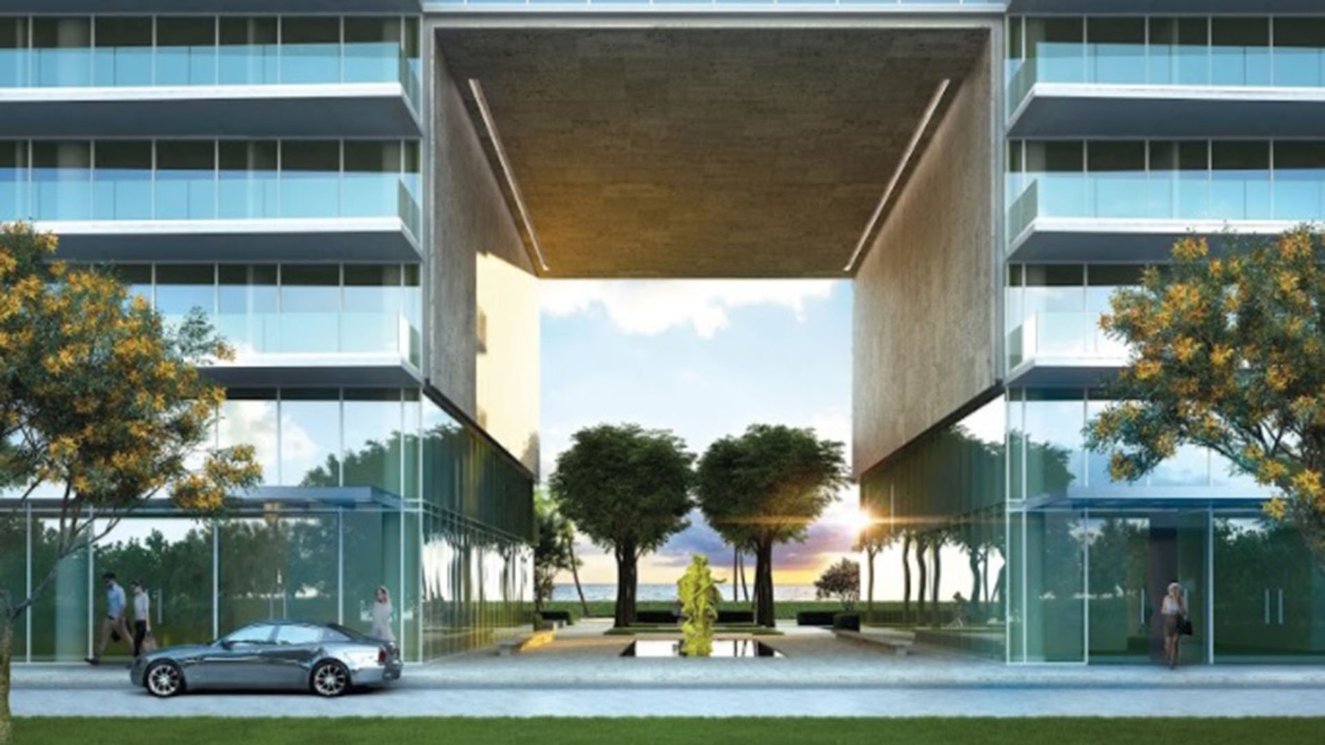 Grand condo entrance framed by twin towers, a reflecting pool and sculpture at Oceana Bal Harbour in Bal Harbour, Florida, setting a memorable luxury arrival for these ultra luxury condos.
