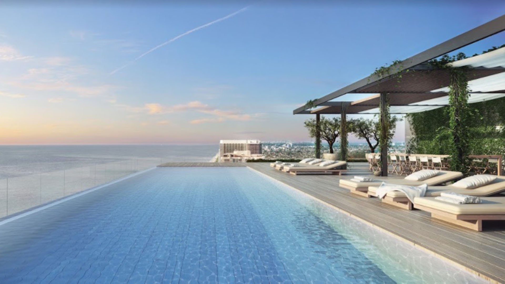 Infinity pool terrace with sun loungers, pergola seating and open water views at Oceana Bal Harbour in Bal Harbour, Florida, capturing the resort style luxury of these ultra luxury condos.