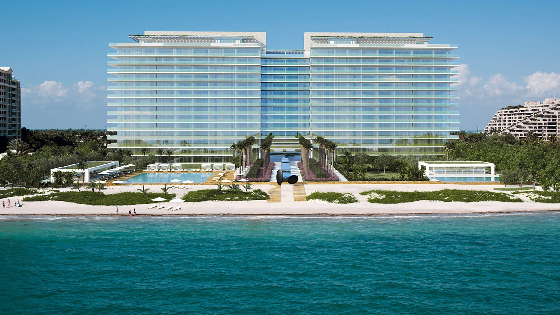 Aerial view of Oceana Key Biscayne in Key Biscayne, where luxury and ultra luxury condos rise above the beach with broad glass balconies, landscaped grounds, pools, and direct waterfront frontage.