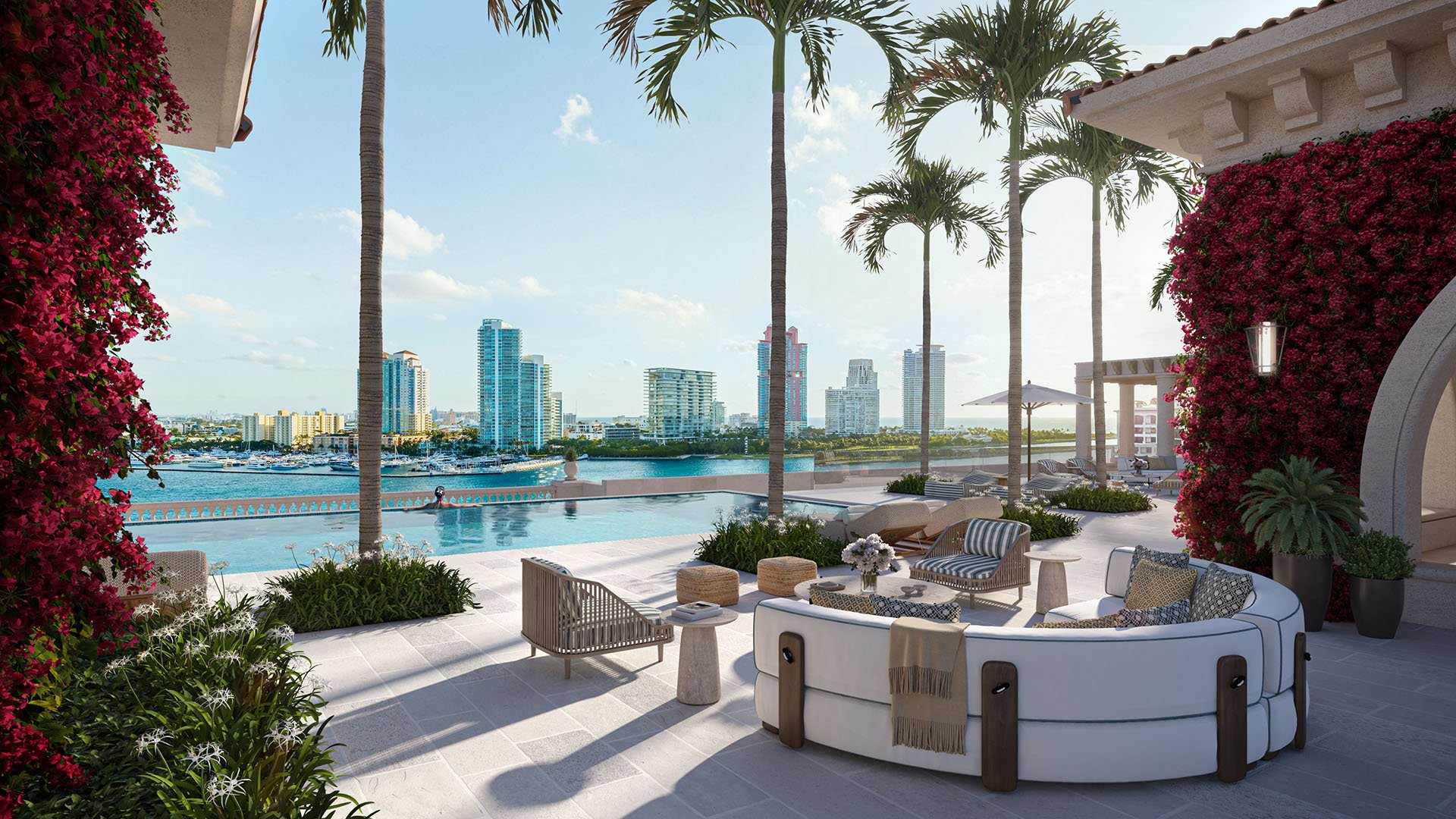 Penthouse terrace pool at The Residences at Six Fisher Island, Fisher Island Miami Beach Florida, with palms and bougainvillea framing Miami skyline and waterfront; luxury and ultra luxury preconstruction condos outdoor amenity.