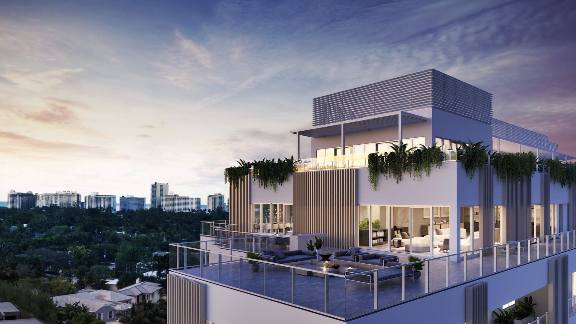Sunset rooftop penthouse terrace at The Ritz-Carlton Residences Miami Beach in Miami Beach, showing luxury and ultra luxury condos with outdoor lounge seating, glowing interiors and a skyline backdrop.
