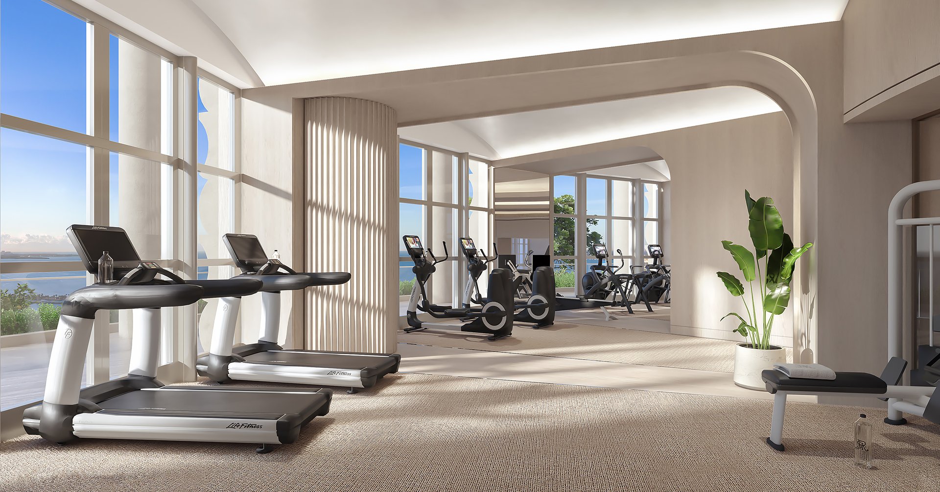 A fully equipped fitness center with sweeping bay views, relaxation area, juice bar, indoor lap pool, pilates and yoga studio, dual sauna, and salt spa room.