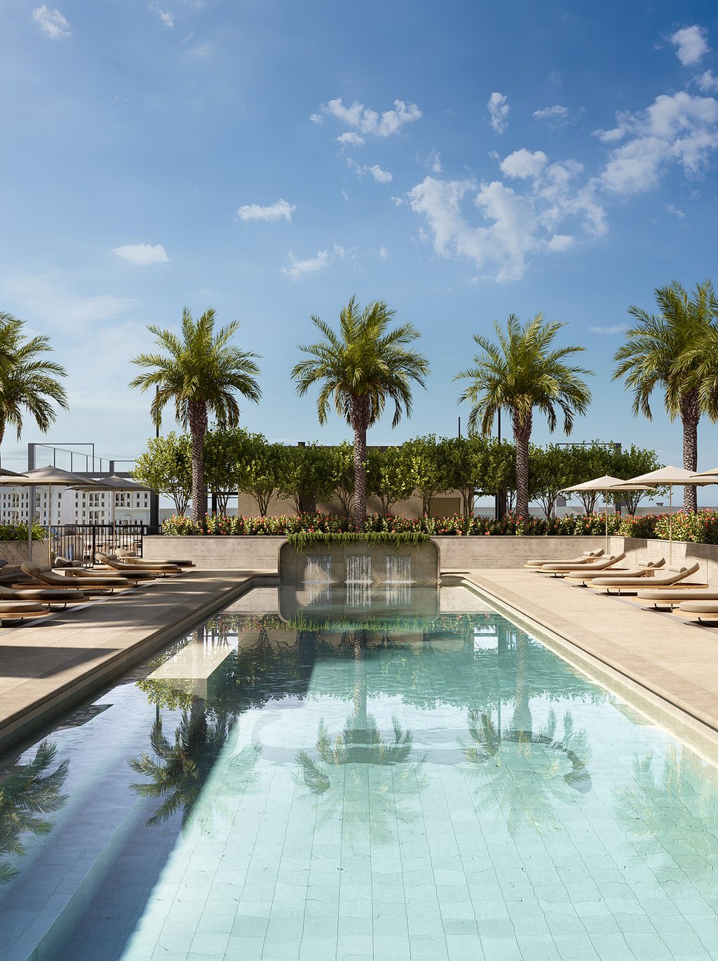 This luxurious rooftop pool area features a sun shelf for lounging and dedicated private cabanas. The area provides a perfect setting for relaxation, sunbathing, and enjoying the beautiful Coral Gables weather in style.