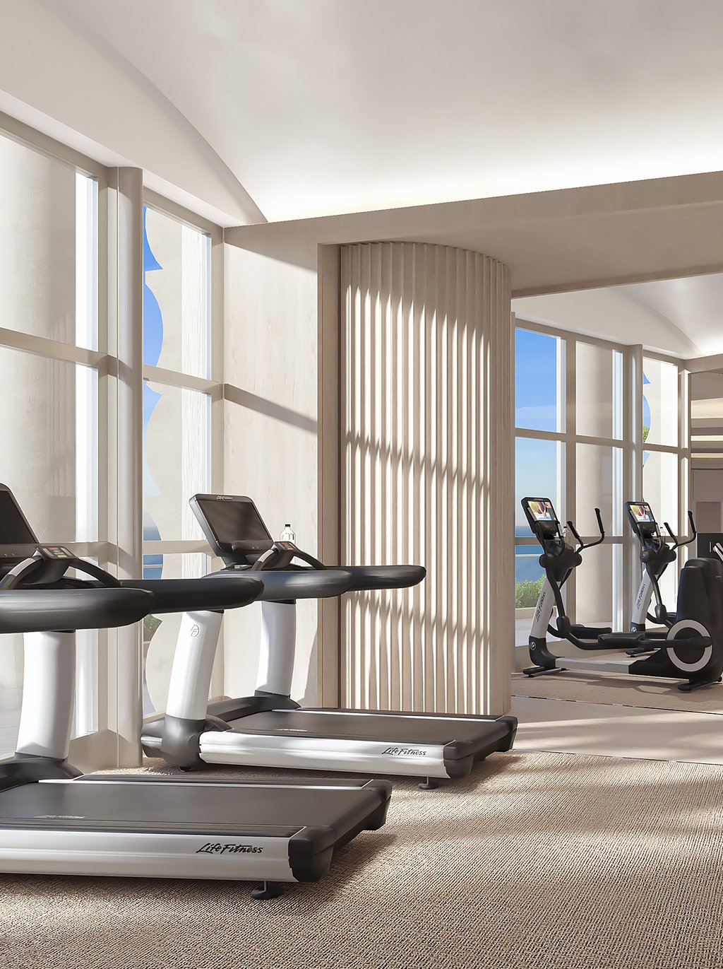A fully equipped fitness center with sweeping bay views, relaxation area, juice bar, indoor lap pool, pilates and yoga studio, dual sauna, and salt spa room.