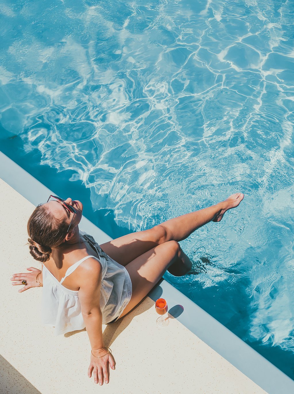 An expansive pool deck with a 75-foot sunrise pool, a sunset hotel pool, a cold plunge pool, a hot tub, and private cabanas for a complete relaxing experience.