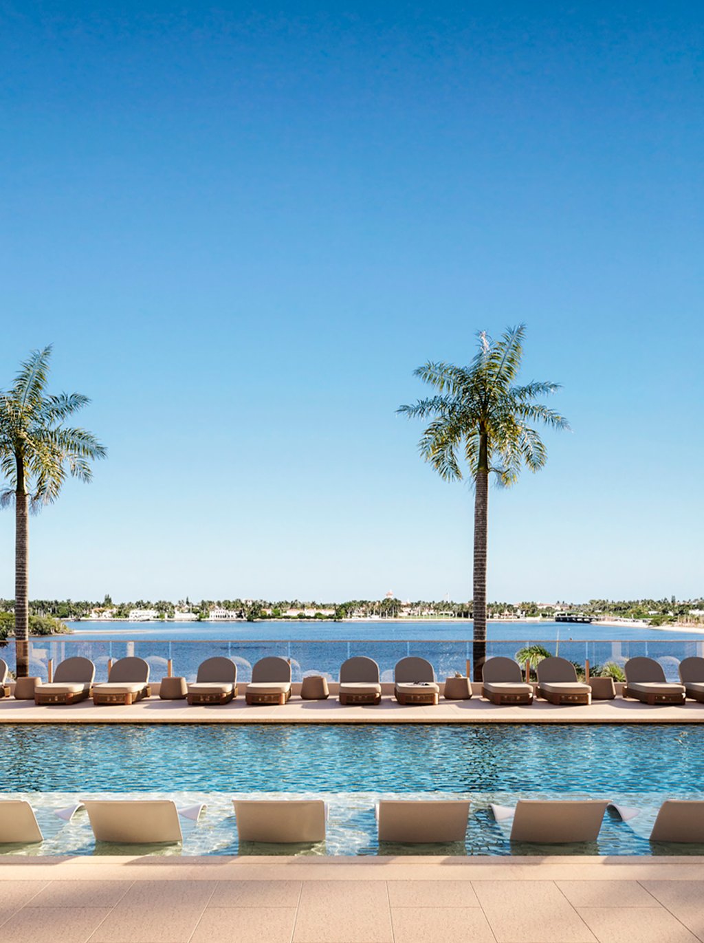 An elevated, east-facing pool and spa terrace is framed by lush tropical landscaping, elegant cabanas, and quiet lounge areas. Designed for sunrise mornings and breezy afternoons, it delivers a resort atmosphere with direct connection to the Intracoastal.